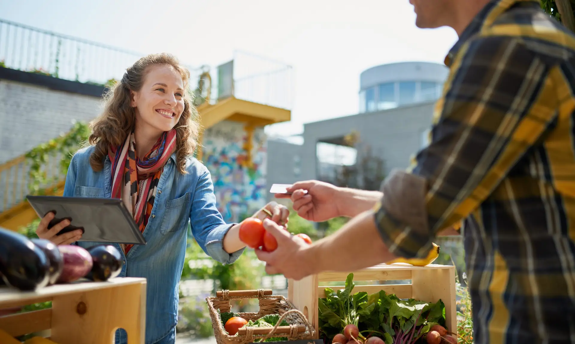 Female gardener selling organic crops while using online payment systems for small business