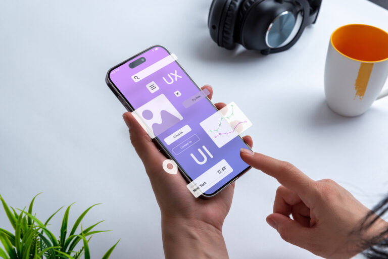 boost website conversions with good ux design represented by a phone with ui and ux