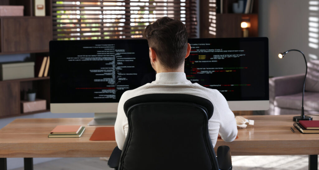 developer working with two monitors to modernize a legacy ios application