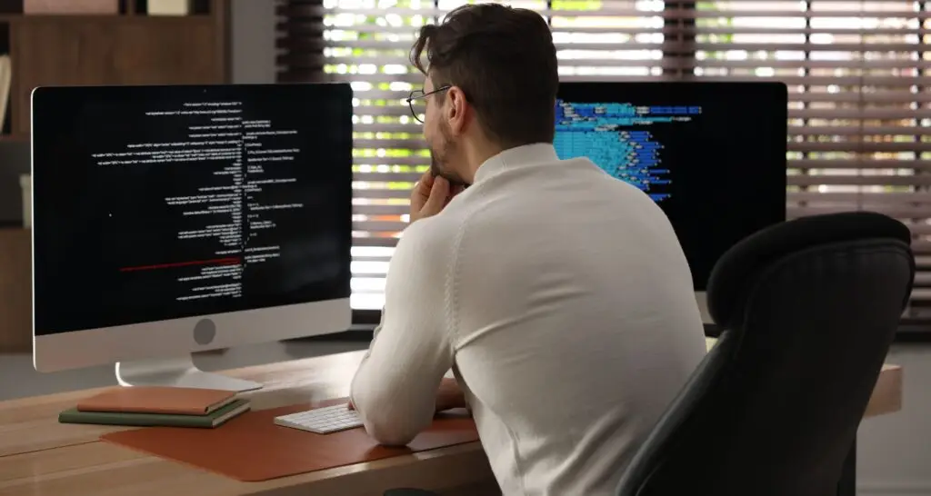 Programmer in glasses working on vibe code cleanup review